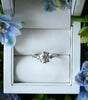 Diamond ring in a white box with floral decorations