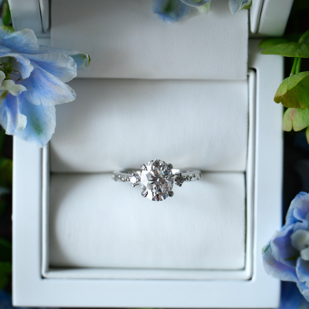 Diamond ring in a white box with floral decorations